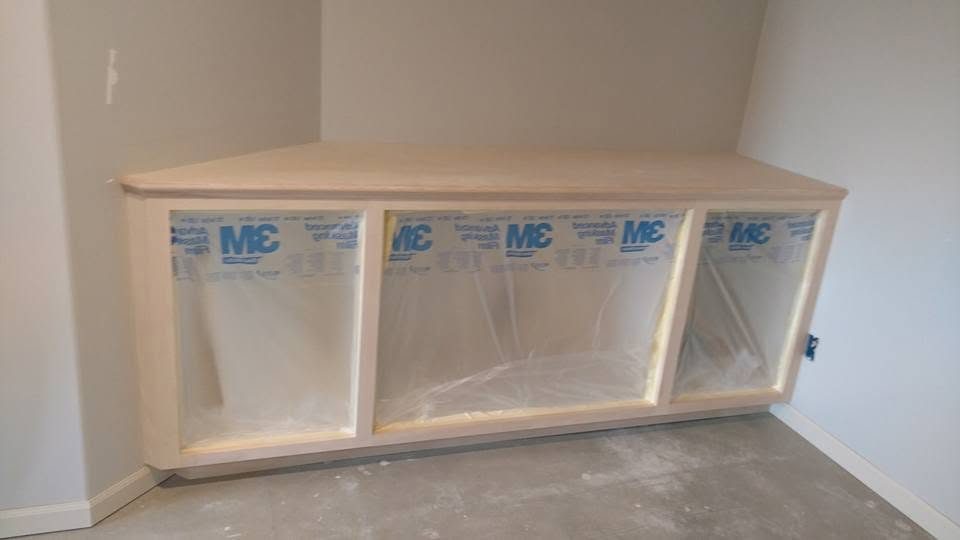 Custom wooden display cabinet with three clear acrylic compartments and blue MC branding labels